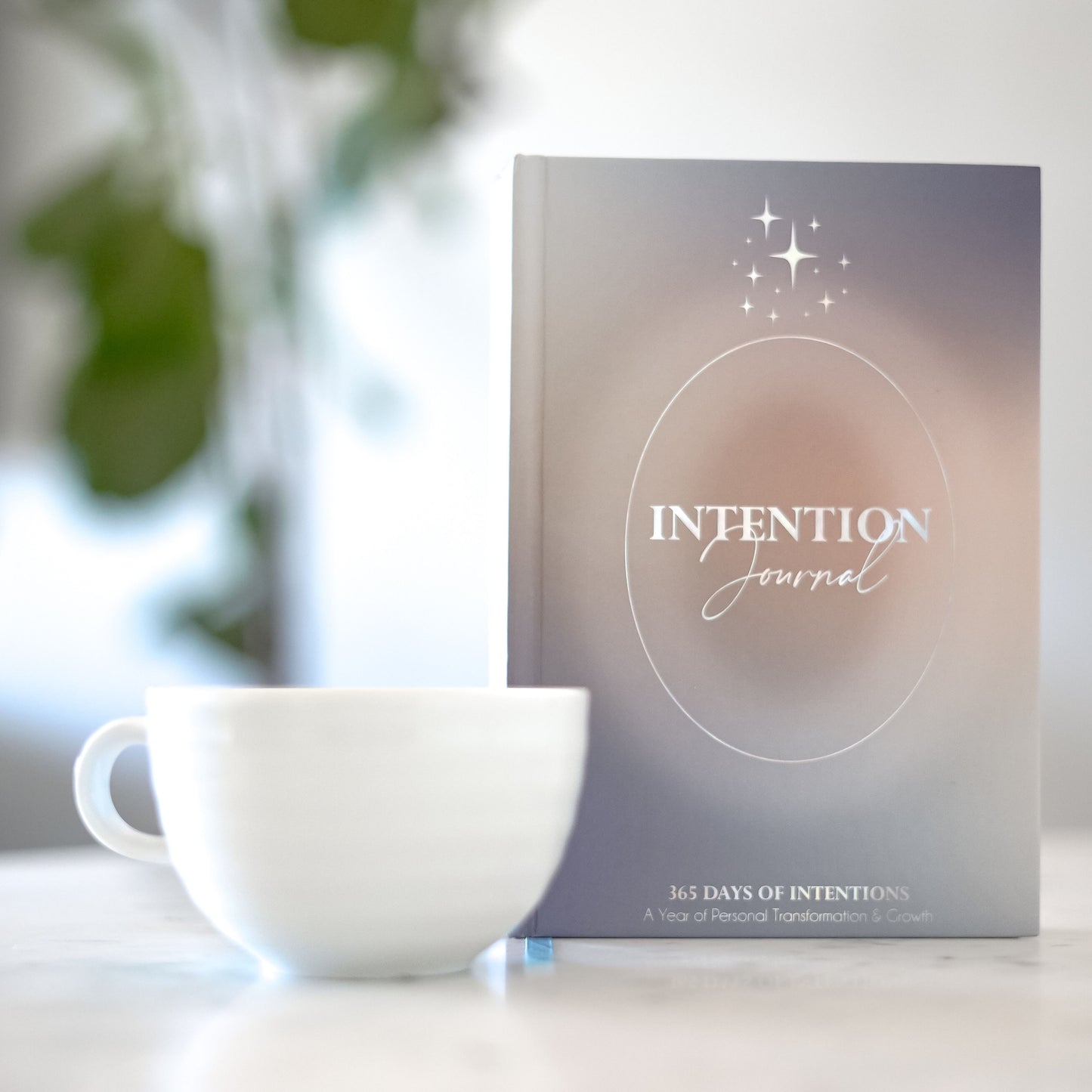 Minimalist hardcover 365 intention journal with a white coffee mug